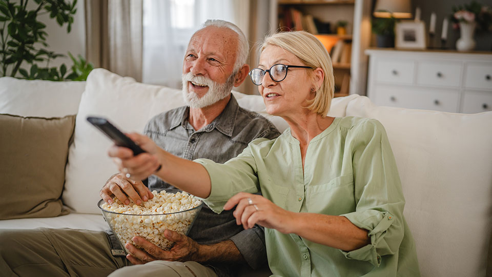 Senior couple watching television