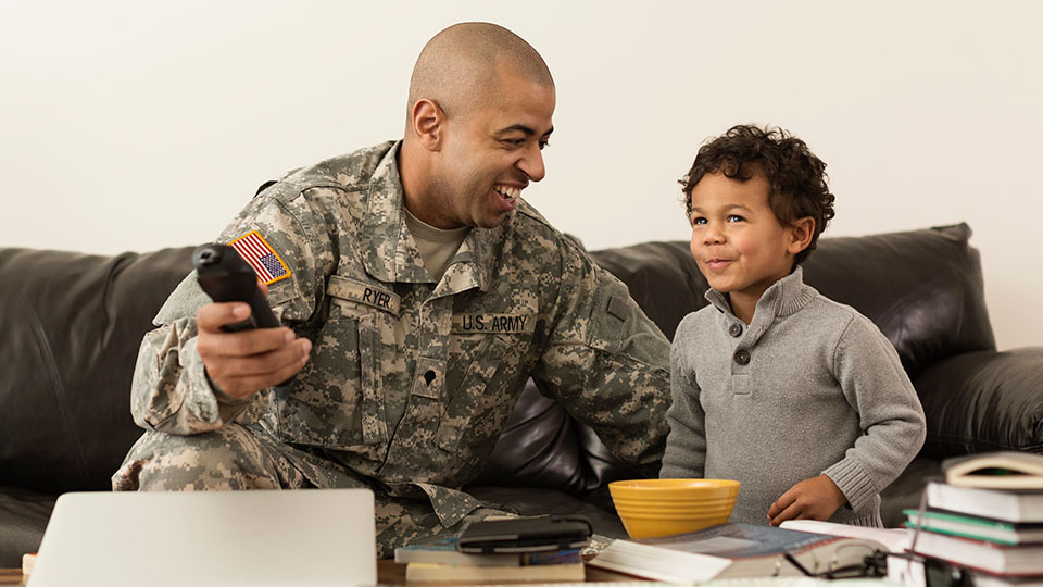 Uniformed Army veteran with child