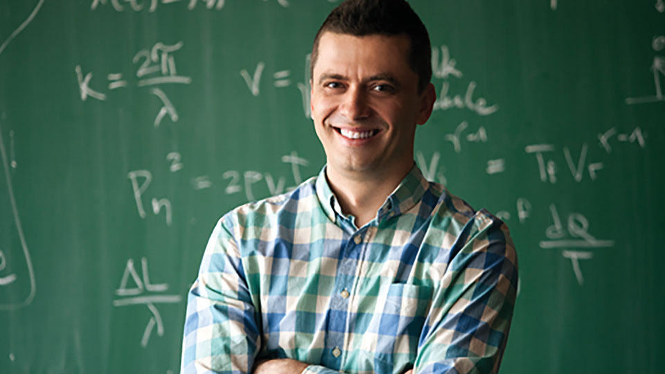 Teacher in front of chalkboard